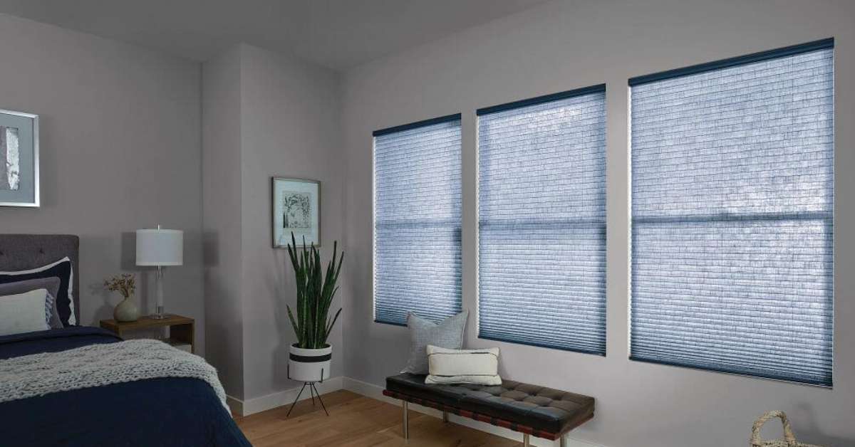 Bedroom features cellular shades for energy-efficient style.